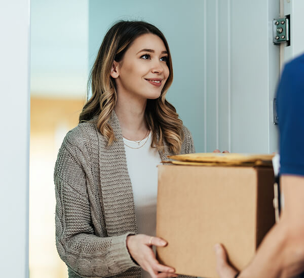 woman-opens-a-cardboard-box-the-parcel-sitting-o-2023-11-27-05-12-56-utc 1 (1)