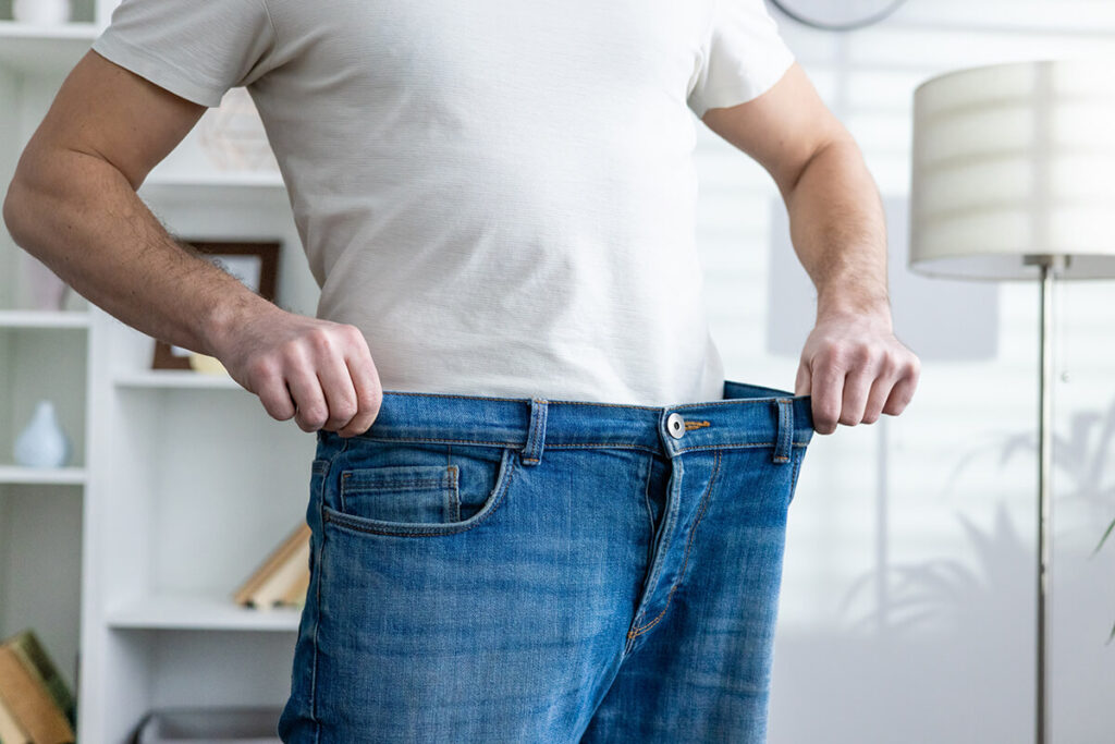 man-showing-weight-loss-by-wearing-loose-jeans-in-2025-03-25-05-08-48-utc (1)